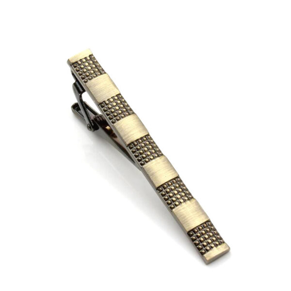 A tie clip with a pattern on it.