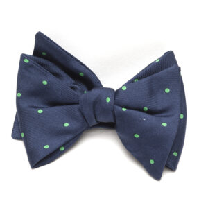 A bow tie with green polka dots on it.