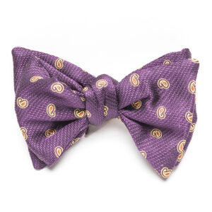 A purple bow tie with yellow and white circles.