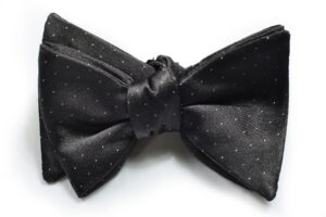 A black bow tie with white dots on it