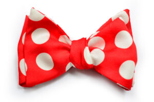A red bow tie with white polka dots on it.