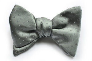 A bow tie with a gray polka dot pattern.