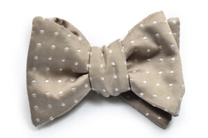 A bow tie with white polka dots on it