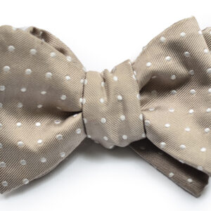 A bow tie with white polka dots on it
