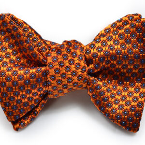 A bow tie with orange and blue pattern on it.