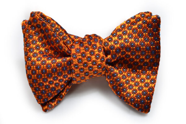 A bow tie with orange and blue pattern on it.