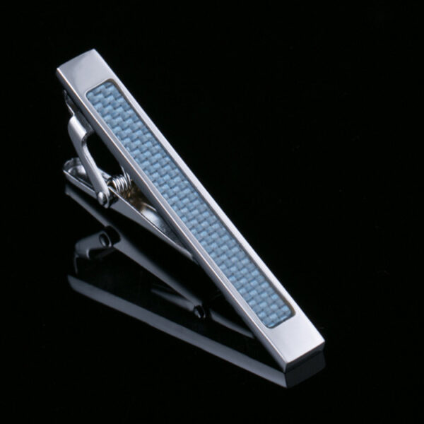 A silver tie bar with blue accents on top of it.